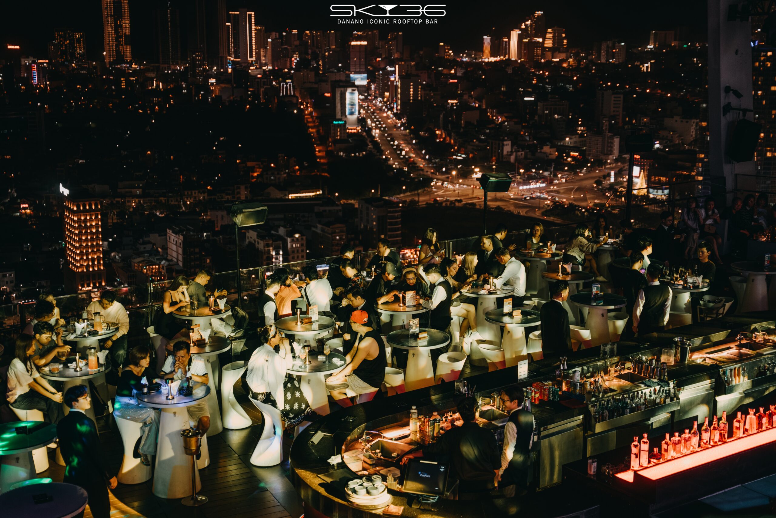Outdoor party event in Da Nang with city lights and guests celebrating at night
